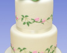 Rose Wedding - Our Entwined Roses (side designs) and Grandiflora (cake topper) decorate this simple but beautiful wedding cake.